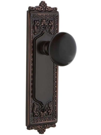 Egg and Dart Style Door Set with Black Porcelain Knobs in Timeless Bronze.